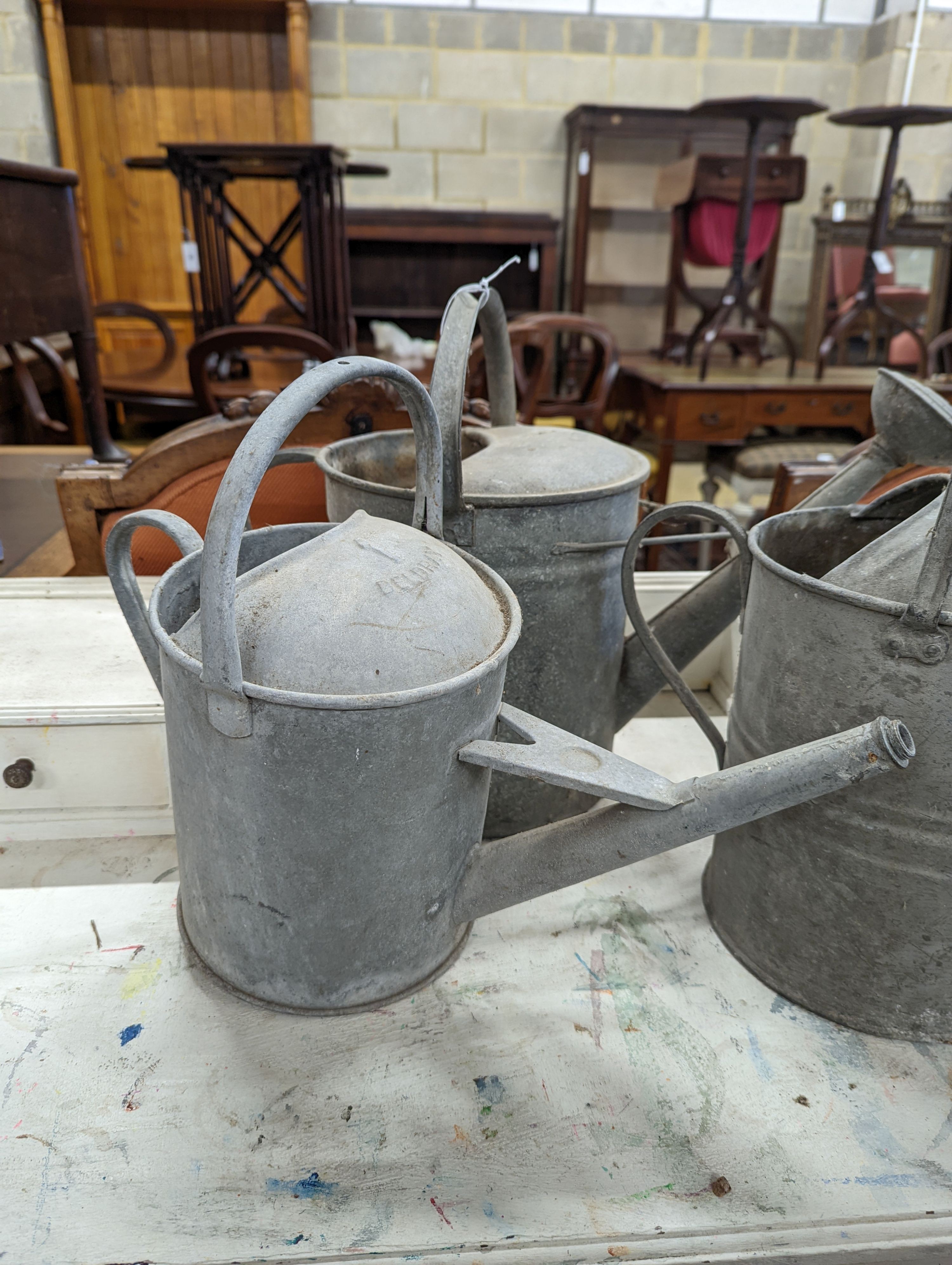 Three vintage galvanized watering cans